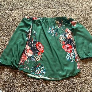 Flattering woman’s green off the shoulder floral top.